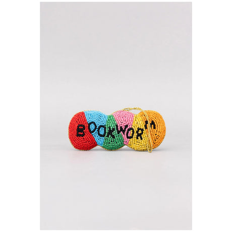 A small beaded accessory with four colorful segments in red, light blue, pink, and yellow, featuring the word 'BOOKWORM' in black beads, set against a plain light gray background.