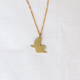 Gold bird-shaped pendant necklace on a white background