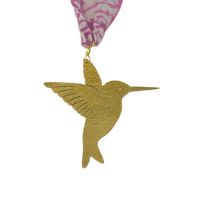 Gold hummingbird ornament with pink and white patterned ribbon on a white background
