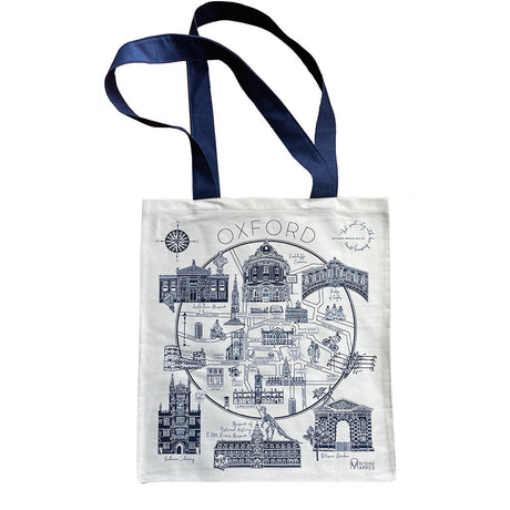 A tote bag featuring a hand-drawn map of Oxford, printed in blue on a white background, with handles and a quote by Oscar Wilde along the bottom.
