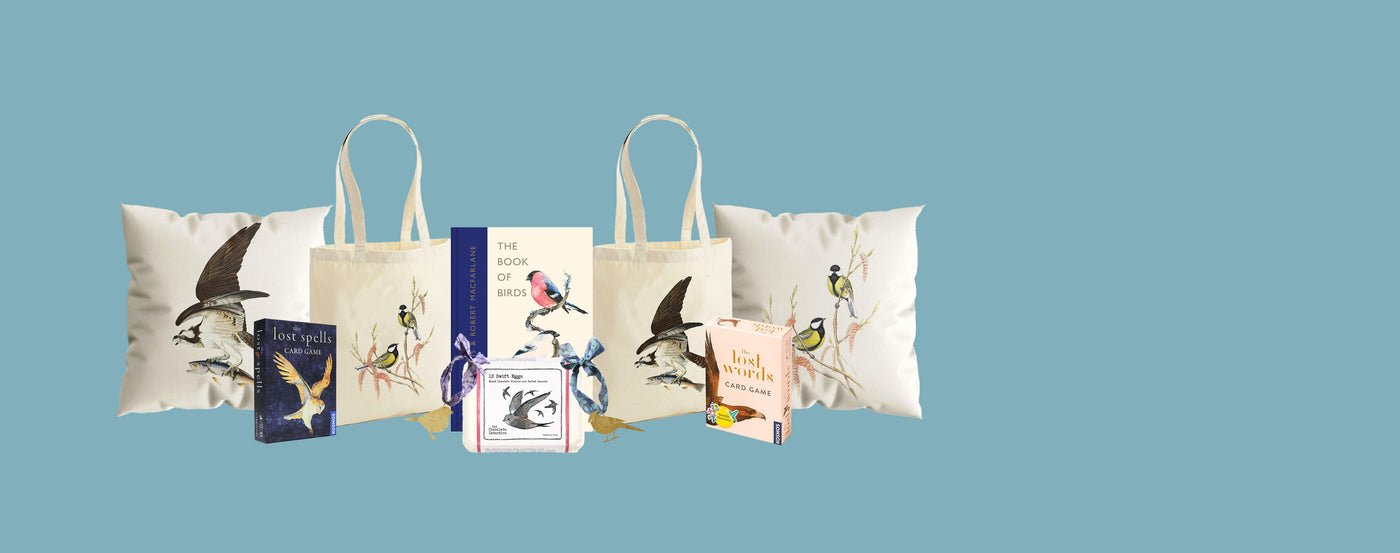 Collection of tote bags and books with nature-themed designs on a blue background