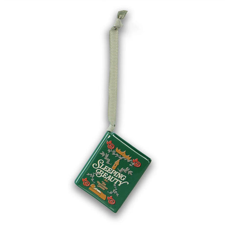 A green rectangular hanging ornament or plaque with the words 'Sleeping Beauty' in white script, decorated with small red flowers, gold accents, and a light beige cord attached at the top, shown on a plain white background.