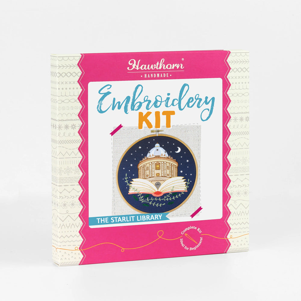 Outer box showcasing embroidery hoop with a design of  the Radcliffe Camera Library inside an open book against a night sky.