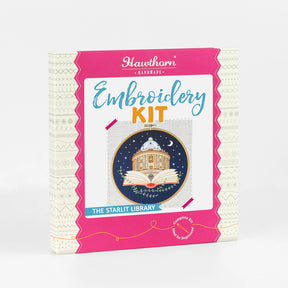 Outer box showcasing embroidery hoop with a design of  the Radcliffe Camera Library inside an open book against a night sky.