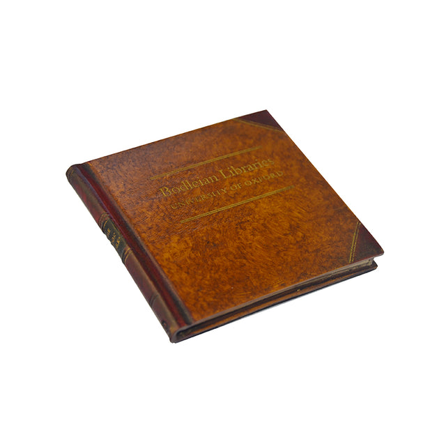 A tan-colored, book-shaped drink coaster with the name 'Bodleian Libraries' printed on the top.