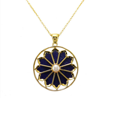 A gold plated necklace with a floral pendant featuring lapis and a pearl.