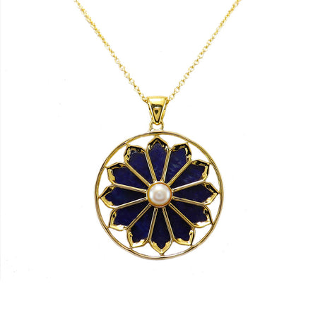 A gold plated necklace with a floral pendant featuring lapis and a pearl.